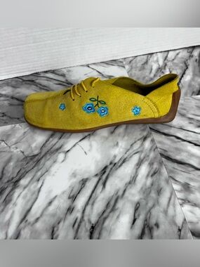 Women’s yellow suede lace up shoes with embroidered details and gum sole
